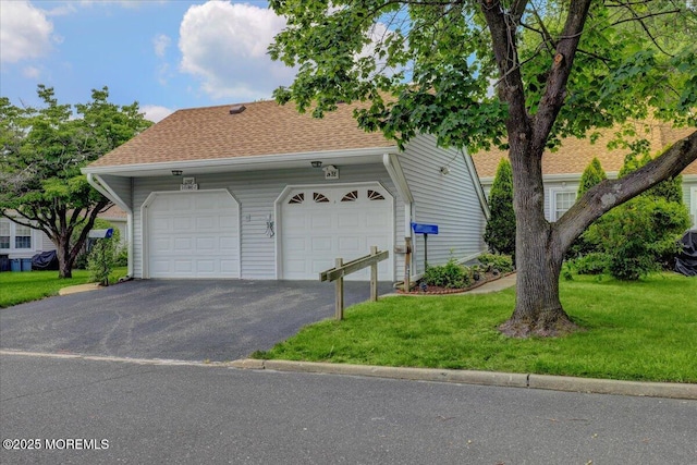 128 Korn Market Unit E, Freehold, NJ 07728 - view of front facade with a front lawn, asphalt driveway, a shingled roof, and a garage