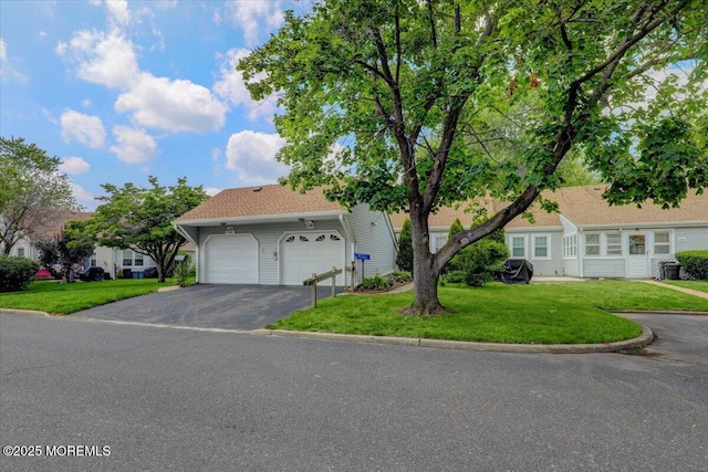 128 Korn Market Unit E, Freehold, NJ 07728 - view of front of property featuring driveway, a front yard, and a garage