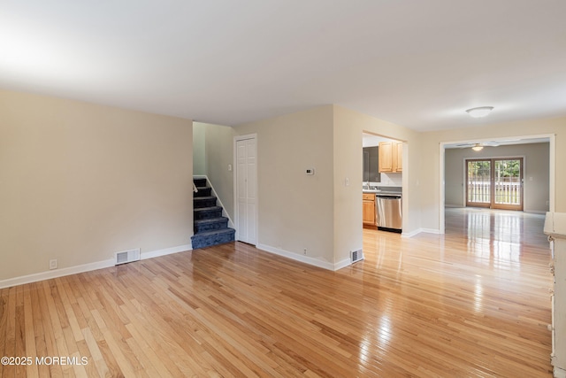 281 Hance Rd, Fair Haven, NJ 07704 - empty room with stairway, light wood-style floors, and a ceiling fan