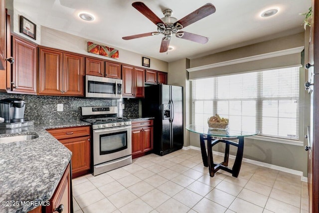 53 Grassmere Ct Unit 1, Freehold, NJ 07728 - kitchen with stainless steel appliances, tasteful backsplash, ceiling fan, light tile patterned floors, and brown cabinetry