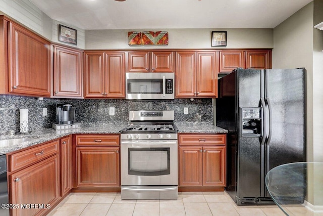 53 Grassmere Ct Unit 1, Freehold, NJ 07728 - kitchen with stainless steel appliances, stone countertops, light tile patterned floors, and backsplash