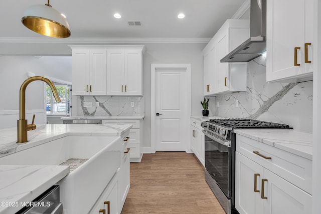 127 Rogers St, Bayville, NJ 08721 - kitchen featuring gas range, wall chimney exhaust hood, crown molding, white cabinets, and light stone counters
