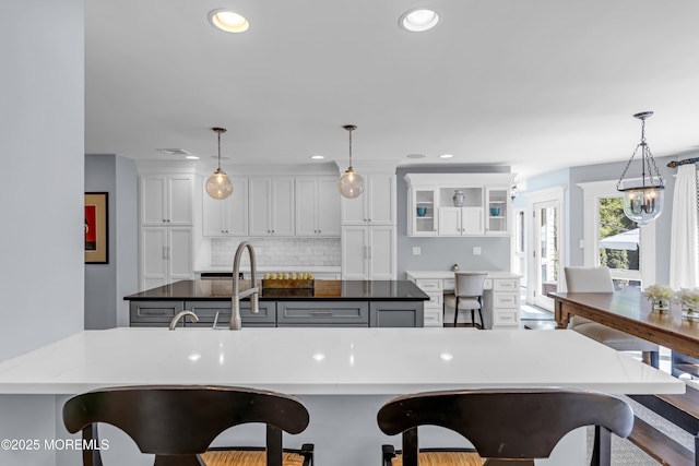 20 Wardell Ave, Rumson, NJ 07760 - kitchen with a breakfast bar area, white cabinetry, backsplash, decorative light fixtures, and recessed lighting