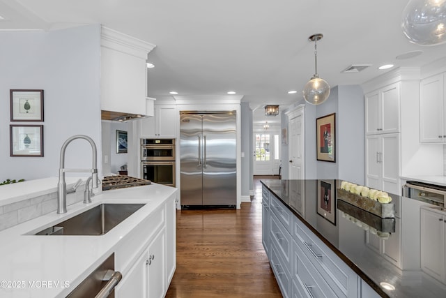 20 Wardell Ave, Rumson, NJ 07760 - kitchen with stainless steel appliances, white cabinets, decorative light fixtures, recessed lighting, and dark wood-style flooring