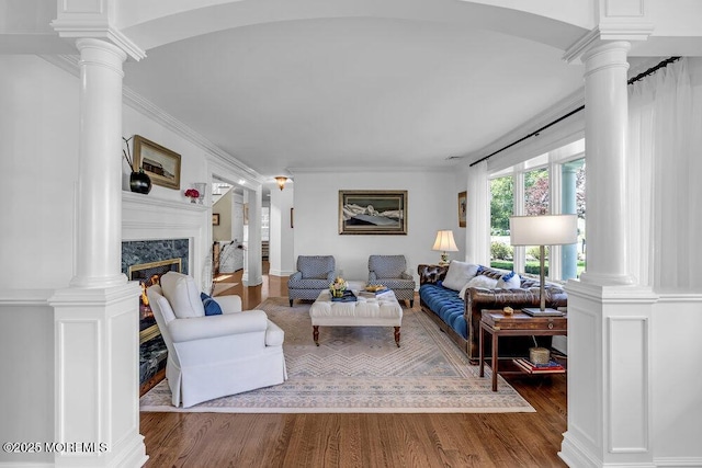 20 Wardell Ave, Rumson, NJ 07760 - living area with decorative columns, wood finished floors, a fireplace, and ornamental molding