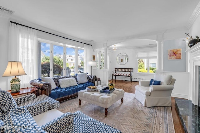 20 Wardell Ave, Rumson, NJ 07760 - living area featuring decorative columns, ornamental molding, wood finished floors, arched walkways, and baseboard heating
