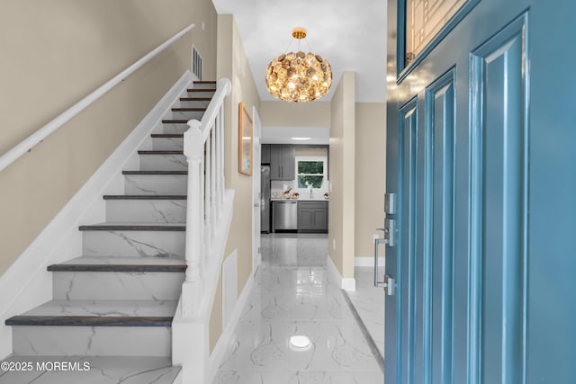1066 Windlass Dr, Manahawkin, NJ 08050 - foyer with light marble finish floors, a chandelier, and stairway