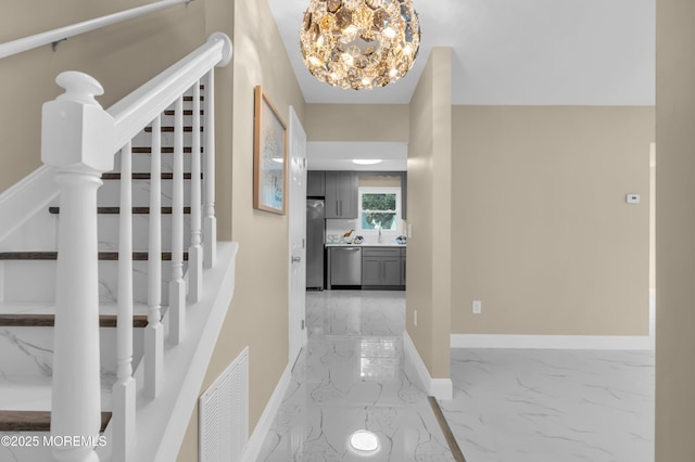 1066 Windlass Dr, Manahawkin, NJ 08050 - hallway featuring light marble finish flooring, stairs, and a chandelier