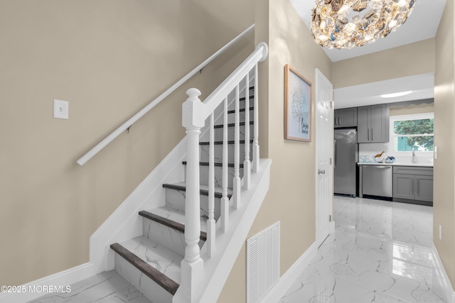 1066 Windlass Dr, Manahawkin, NJ 08050 - staircase featuring marble finish flooring and a chandelier