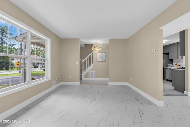 1066 Windlass Dr, Manahawkin, NJ 08050 - unfurnished room featuring light marble finish flooring, stairway, and a chandelier