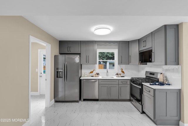 1066 Windlass Dr, Manahawkin, NJ 08050 - kitchen featuring gray cabinets, stainless steel appliances, light marble finish flooring, and light countertops