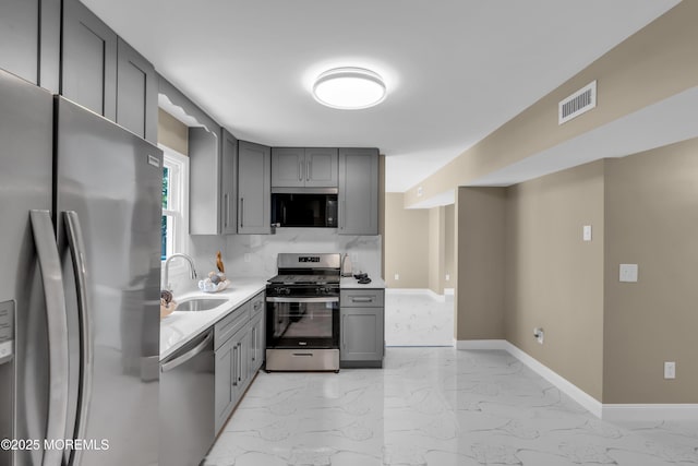 1066 Windlass Dr, Manahawkin, NJ 08050 - kitchen featuring gray cabinets, light marble finish flooring, appliances with stainless steel finishes, and light countertops
