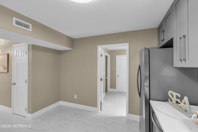 1066 Windlass Dr, Manahawkin, NJ 08050 - kitchen with light marble finish floors, gray cabinetry, and light stone counters