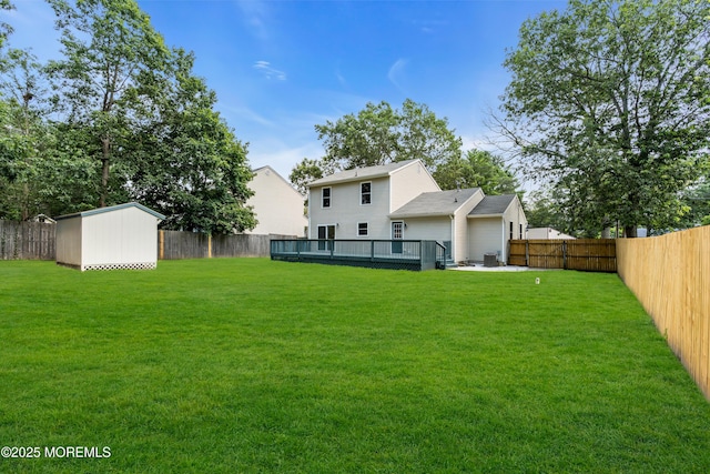 1066 Windlass Dr, Manahawkin, NJ 08050 - back of property featuring a fenced backyard, a deck, and a storage shed