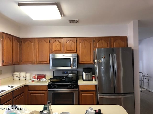 106 Narberth Way, Toms River, NJ 08757 - kitchen featuring stainless steel appliances, light countertops, and brown cabinetry
