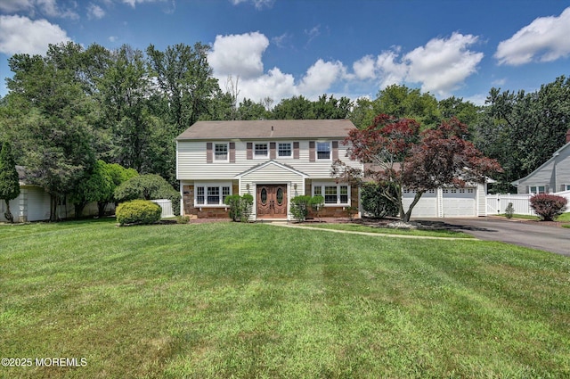 25 Forman Ln, Manalapan, NJ 07726 - colonial house featuring driveway, a garage, and a front lawn