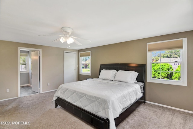 25 Forman Ln, Manalapan, NJ 07726 - carpeted bedroom featuring multiple windows, ceiling fan, and connected bathroom
