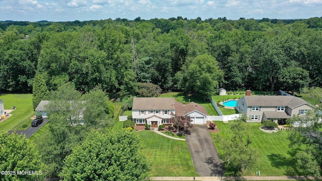 25 Forman Ln, Manalapan, NJ 07726 - drone / aerial view of a heavily wooded area and a pool area