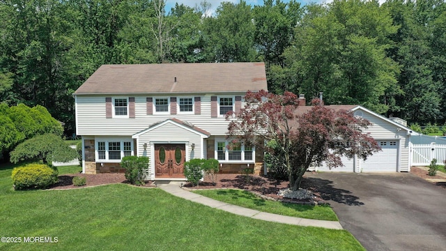 25 Forman Ln, Manalapan, NJ 07726 - colonial house with driveway, stone siding, an attached garage, and a chimney