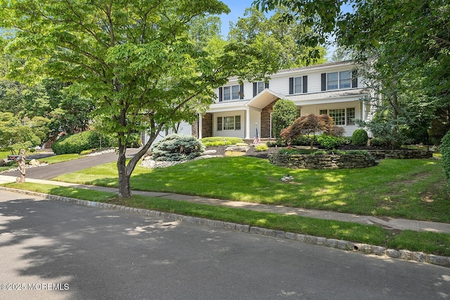 7 Lorraine Ct, East Brunswick, NJ 08816 - view of front facade featuring asphalt driveway, a garage, a front yard, and stone siding