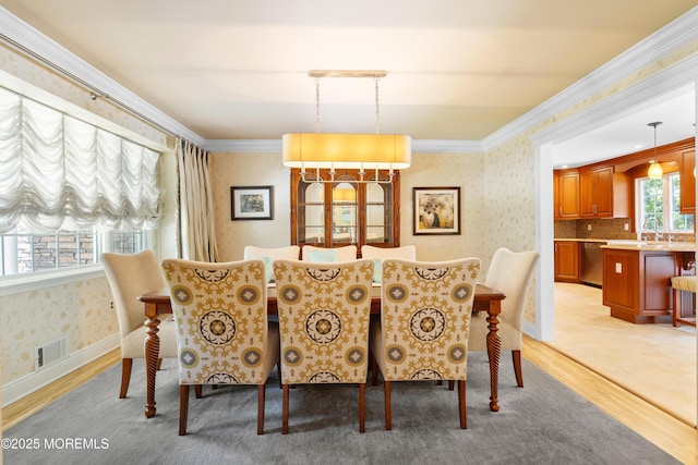 7 Lorraine Ct, East Brunswick, NJ 08816 - dining room with wallpapered walls, light wood-type flooring, and crown molding