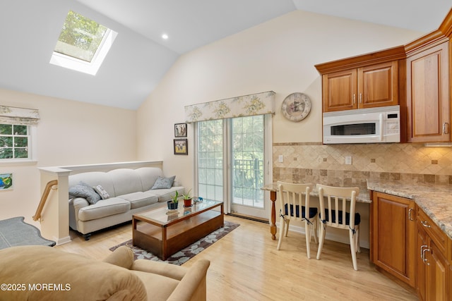 7 Lorraine Ct, East Brunswick, NJ 08816 - living area with lofted ceiling, a skylight, light wood-style floors, and healthy amount of natural light