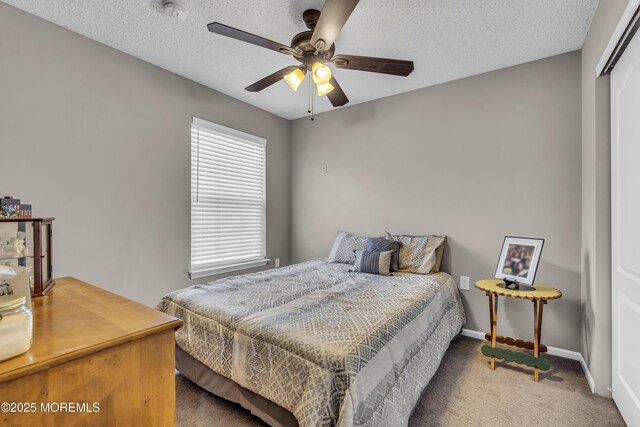 1602 Wagon Wheel Ct, Freehold, NJ 07728 - carpeted bedroom with a closet, a textured ceiling, and a ceiling fan