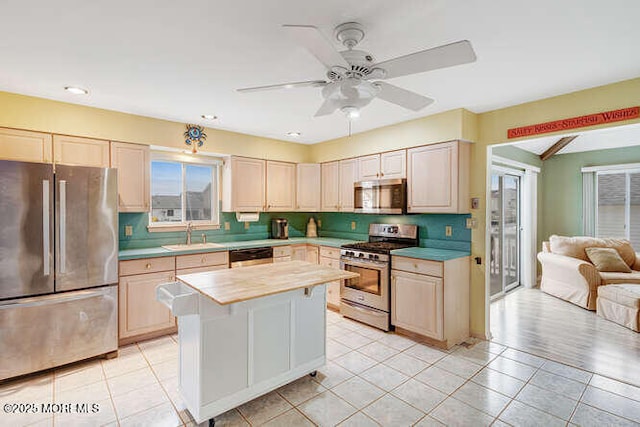 12 Peggy Ln, Beach Haven West, NJ 08050 - kitchen with stainless steel appliances, a ceiling fan, a kitchen island, light tile patterned flooring, and light brown cabinetry