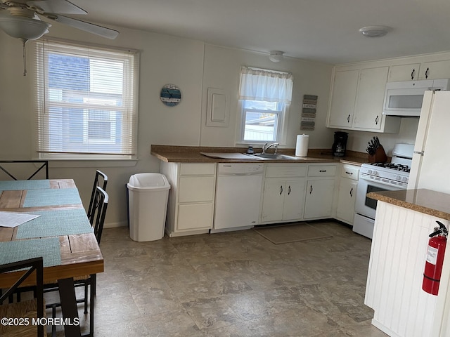 25 E 49th St, Long Beach Twp, NJ 08008 - kitchen featuring white appliances, healthy amount of natural light, a ceiling fan, and dark countertops