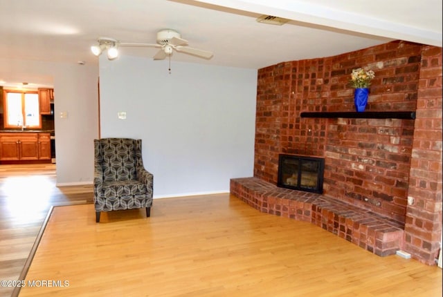 1111 River Ave, Point Pleasant, NJ 08742 - living room featuring ceiling fan, light wood finished floors, and a brick fireplace