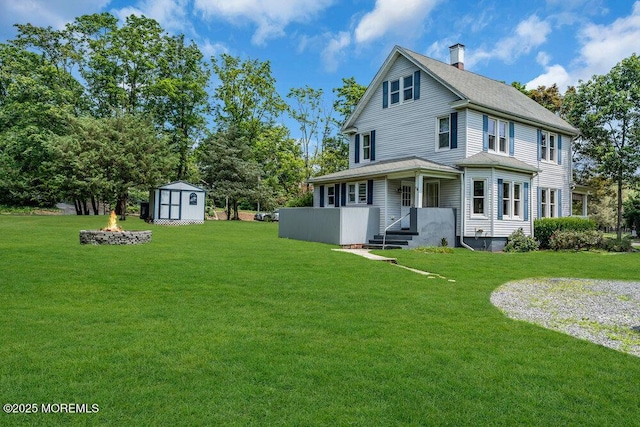 660 Herbertsville Rd, Brick, NJ 08724 - back of house featuring a fire pit, a storage shed, a yard, a chimney, and a shingled roof