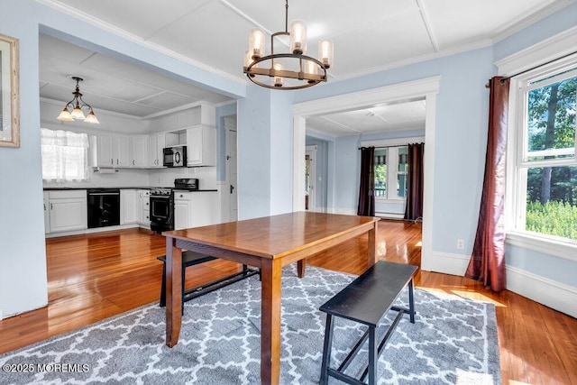 660 Herbertsville Rd, Brick, NJ 08724 - dining room with a chandelier, wood finished floors, and ornamental molding