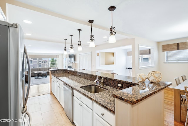 507 Amber St Unit B, Beach Haven, NJ 08008 - kitchen featuring appliances with stainless steel finishes, open floor plan, white cabinetry, pendant lighting, and dark stone counters