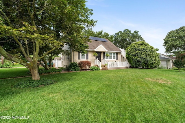 529 Smith Dr, Point Pleasant, NJ 08742 - view of front of home featuring solar panels, a front lawn, and roof with shingles