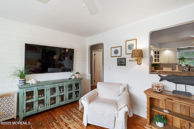 529 Smith Dr, Point Pleasant, NJ 08742 - sitting room featuring arched walkways, ceiling fan, wood finished floors, and wood walls