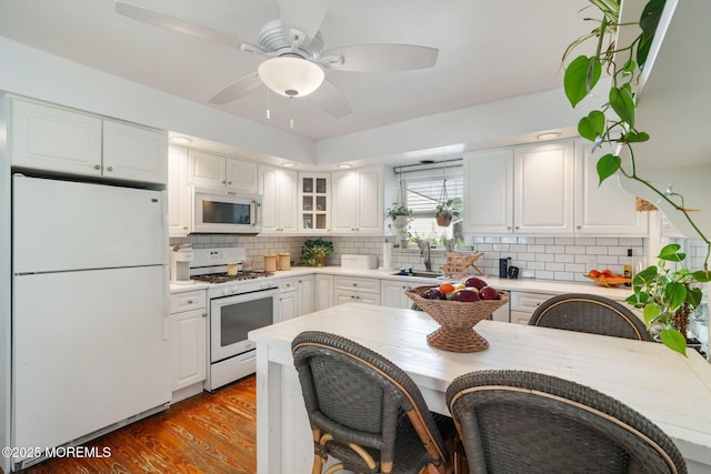 529 Smith Dr, Point Pleasant, NJ 08742 - kitchen with white appliances, white cabinetry, backsplash, and light countertops