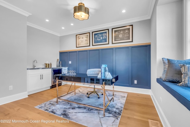 116 Eagle Way, Eatontown, NJ 07724 - office with wine cooler, a decorative wall, crown molding, light wood-style flooring, and wet bar