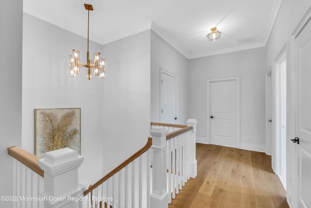 116 Eagle Way, Eatontown, NJ 07724 - hall featuring an upstairs landing, light wood finished floors, crown molding, and a chandelier