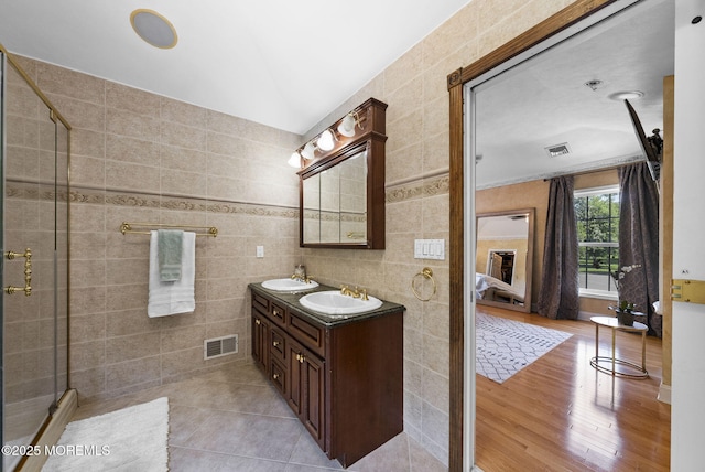 6 Tower Ct, Farmingdale, NJ 07727 - bathroom with double vanity, a stall shower, tile walls, and wood finished floors