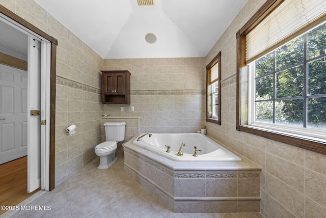 6 Tower Ct, Farmingdale, NJ 07727 - bathroom featuring tile walls, a jetted tub, plenty of natural light, vaulted ceiling, and tile patterned floors