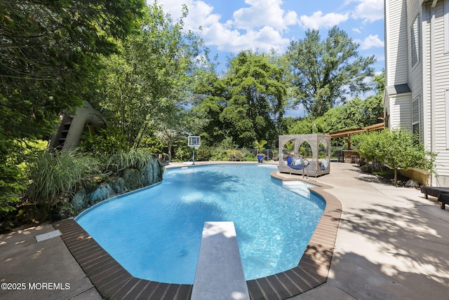 6 Tower Ct, Farmingdale, NJ 07727 - swimming pool with a diving board, a patio area, and view of wooded area