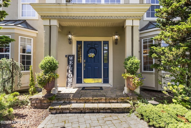 6 Tower Ct, Farmingdale, NJ 07727 - view of exterior entry with stucco siding and a standing seam roof