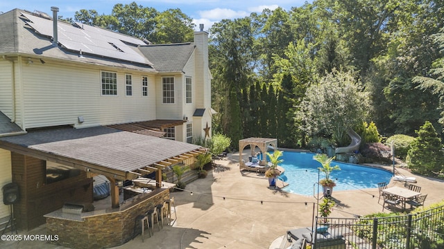 6 Tower Ct, Farmingdale, NJ 07727 - view of pool with a water slide, a patio area, and a pergola