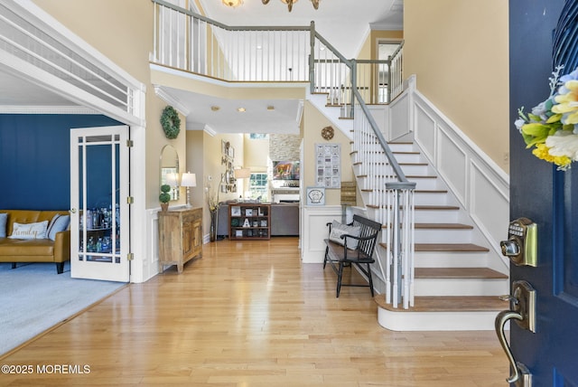 6 Tower Ct, Farmingdale, NJ 07727 - entryway featuring a decorative wall, stairway, ornamental molding, a towering ceiling, and a wainscoted wall