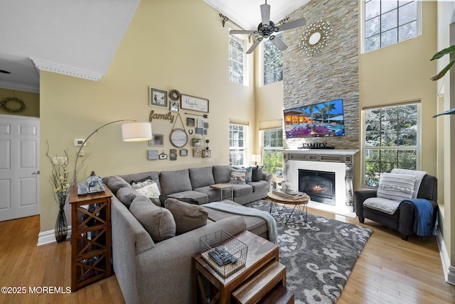 6 Tower Ct, Farmingdale, NJ 07727 - living room with a high ceiling, crown molding, healthy amount of natural light, a ceiling fan, and a fireplace