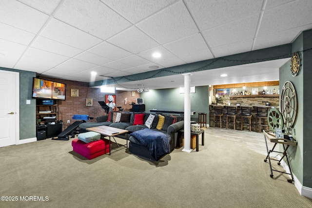 6 Tower Ct, Farmingdale, NJ 07727 - carpeted living room featuring a dry bar, a paneled ceiling, and brick wall