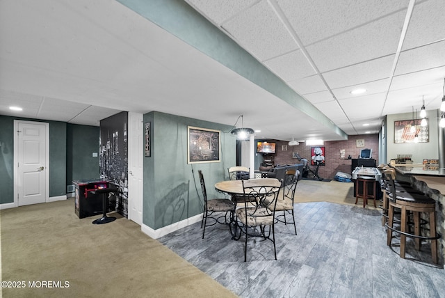 6 Tower Ct, Farmingdale, NJ 07727 - dining area featuring a drop ceiling, brick wall, recessed lighting, and wood finished floors