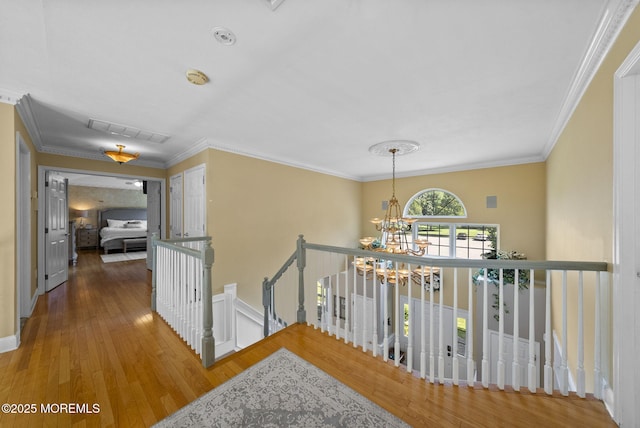 6 Tower Ct, Farmingdale, NJ 07727 - hall featuring an upstairs landing, a chandelier, wood finished floors, and crown molding