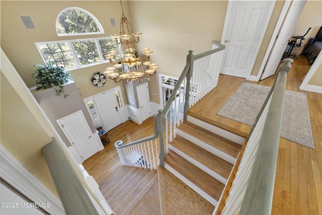 6 Tower Ct, Farmingdale, NJ 07727 - staircase with a chandelier, a high ceiling, and wood finished floors