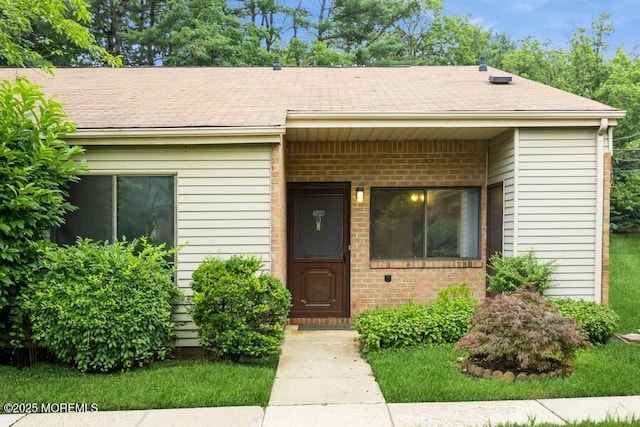 239 Medford Ct Unit B, Manalapan, NJ 07726 - view of front of house featuring brick siding and roof with shingles